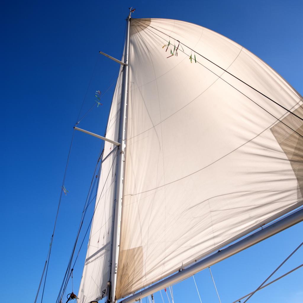 Looking up at the sails of a yacht